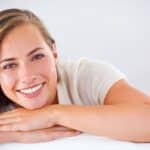 Woman smiling, revealing her bright, straight teeth after Smile By Tonight treatment